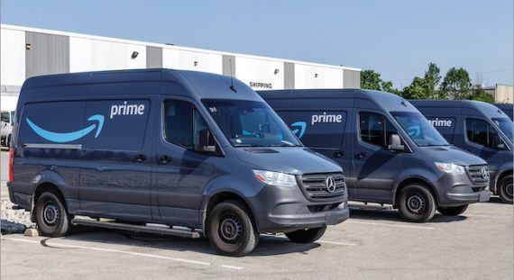 Amazon delivery vans in a parking lot Amazon delivery vans in a parking lot