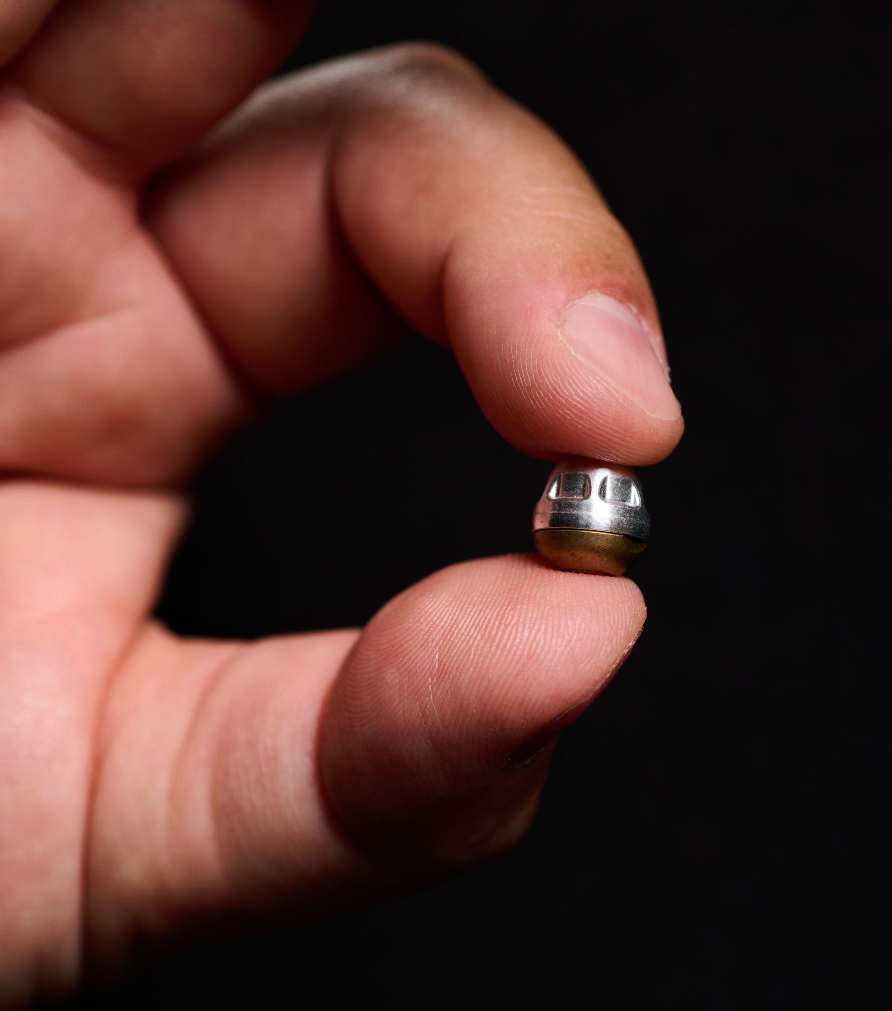 hand holding a spherical metal object