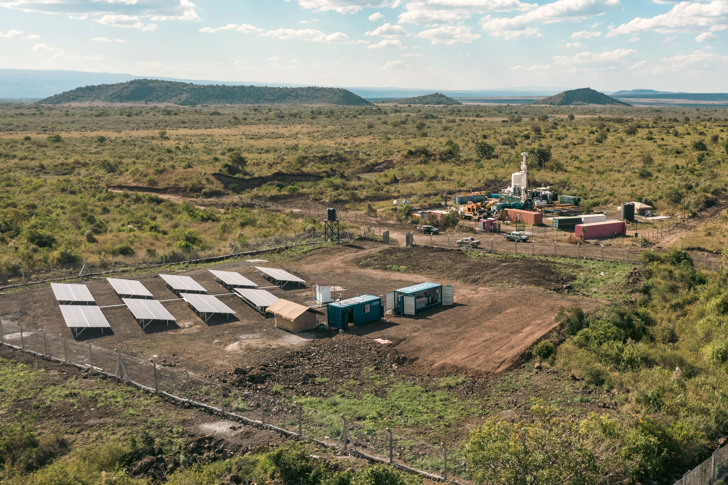 drone view of shipping container buildings next to a solar array