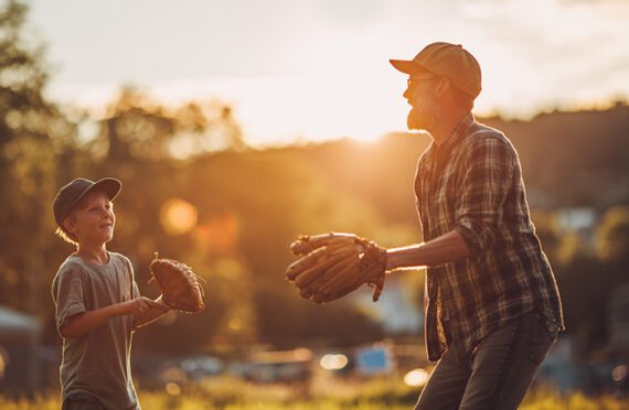 Image of a father and son playing baseball Image of a father and son playing baseball