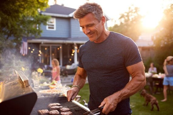 Image of a male cooking outdoors on a grill Image of a male cooking outdoors on a grill