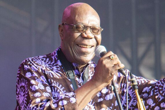 Manu Dibango holding a microphone